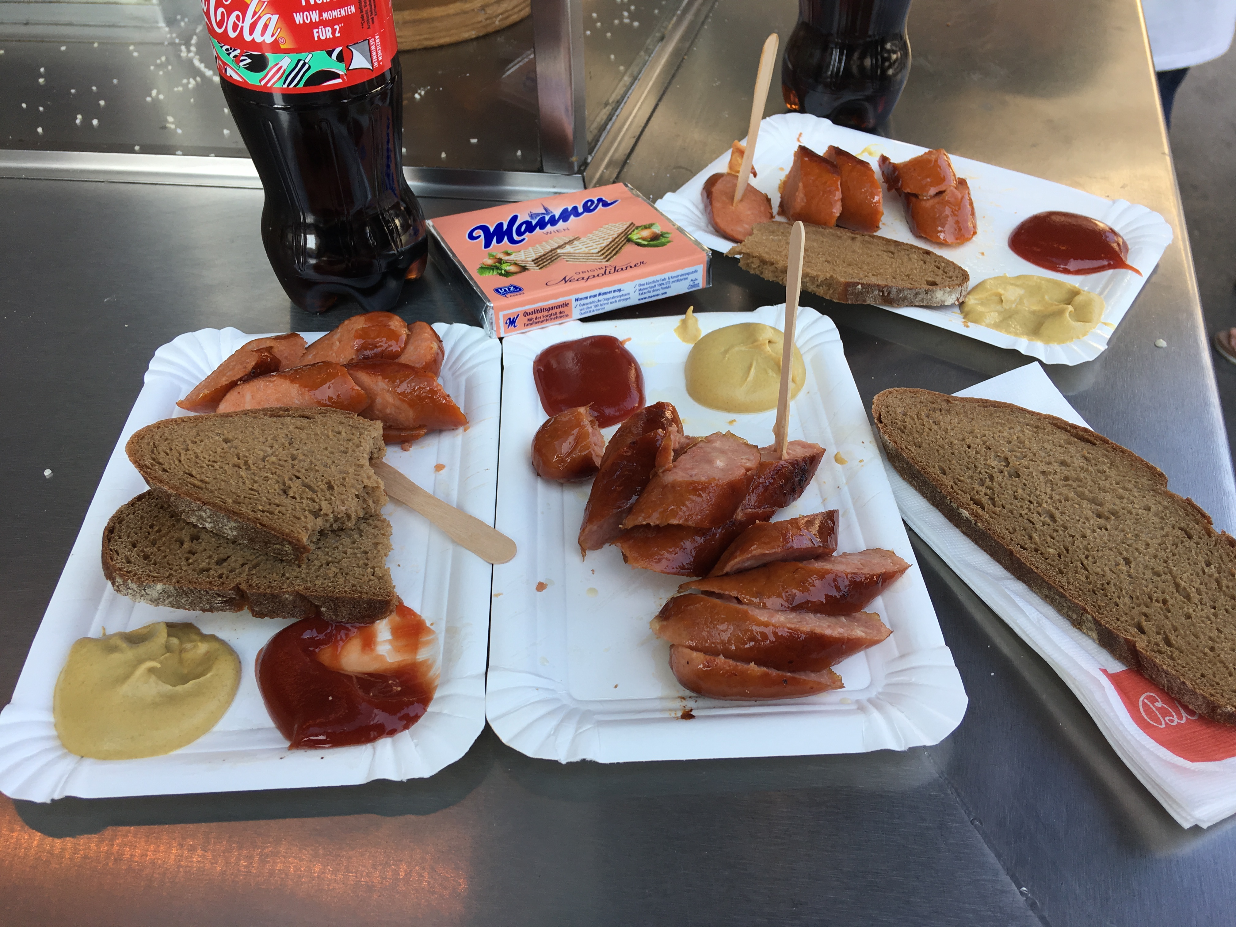 Eating sausages at a streetside vendor