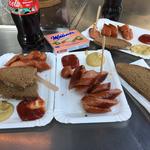 Eating sausages at a streetside vendor